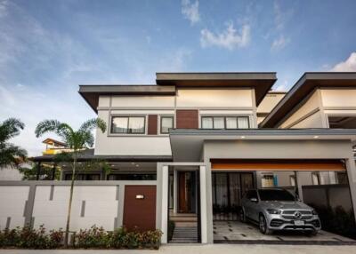 Modern two-story house with garage and a car in the driveway