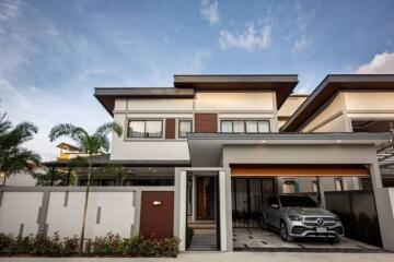 Modern two-story house with garage and a car in the driveway