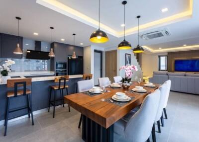 Modern open concept kitchen and living area with dining table