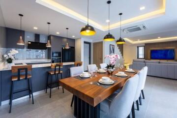 Modern open concept kitchen and living area with dining table