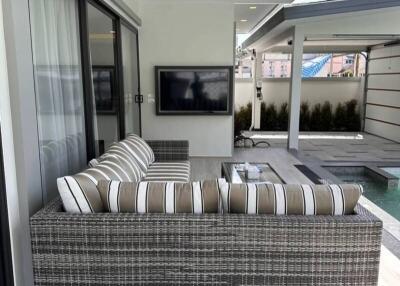 Outdoor patio with sofa and TV