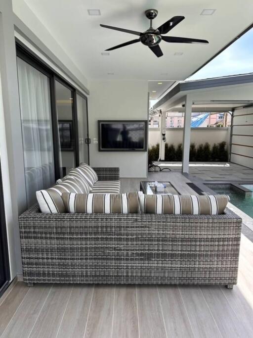 Outdoor patio with sofa and TV