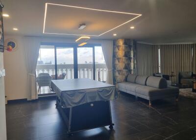 Living room with a pool table, sofa, and balcony access