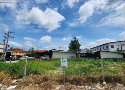 Vacant land with clear skies and nearby buildings