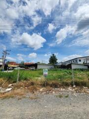 Vacant land with clear skies and nearby buildings