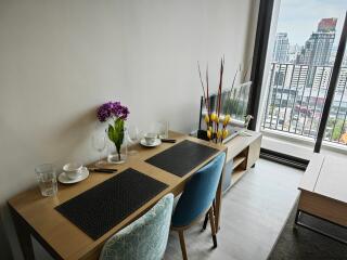 Modern dining area with table setup and city view