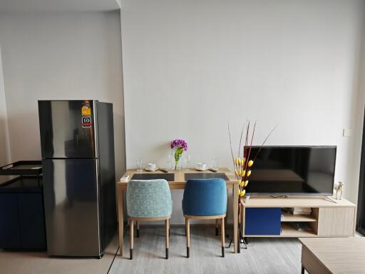 Modern living area with dining set and flat-screen TV