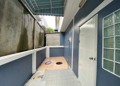 outdoor utility area with blue and white walls