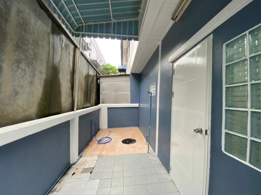 outdoor utility area with blue and white walls