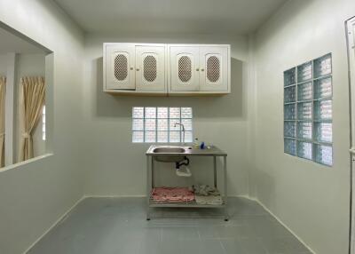 Small kitchen with stainless steel sink and cabinets