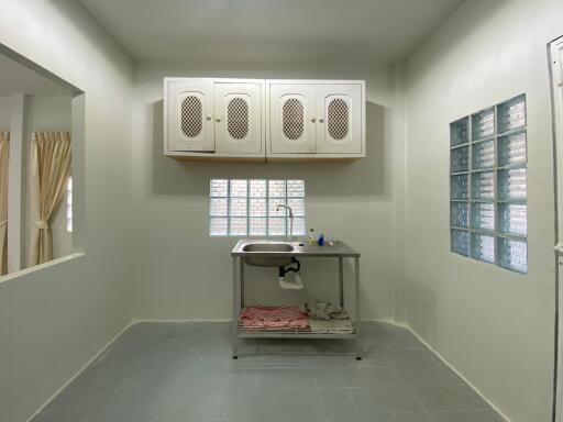 Small kitchen with stainless steel sink and cabinets