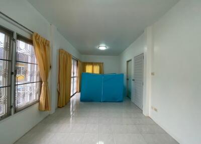 Unfurnished room with tiled floor and windows with golden curtains