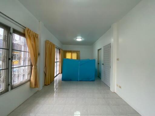 Unfurnished room with tiled floor and windows with golden curtains