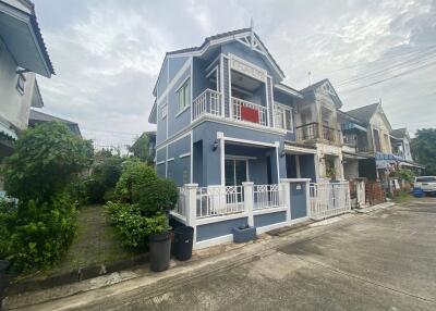 Two-story blue house with balcony and front porch