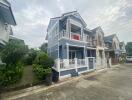 Two-story blue house with balcony and front porch