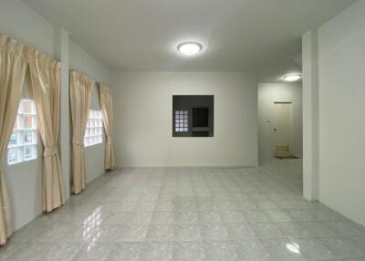 Spacious living room with tiled flooring and large windows