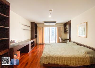 Spacious bedroom with large windows and ample natural light