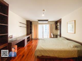 Spacious bedroom with large windows and ample natural light