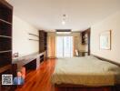 Spacious bedroom with large windows and ample natural light