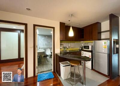 Modern kitchen with adjacent bathroom and living area