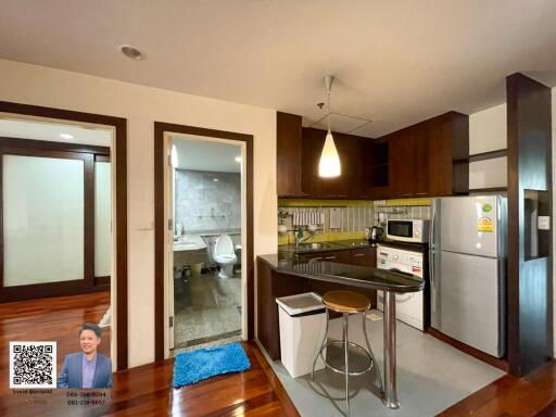 Modern kitchen with adjacent bathroom and living area