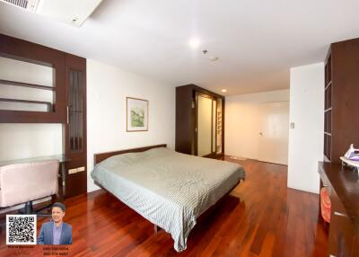 Spacious bedroom with wooden floor