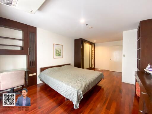 Spacious bedroom with wooden floor