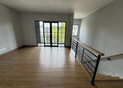 Spacious main living area with large windows and balcony access