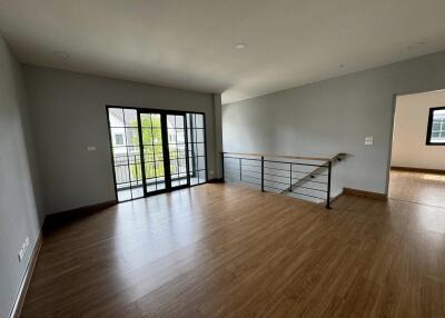 Spacious modern living room with wooden floor and large windows