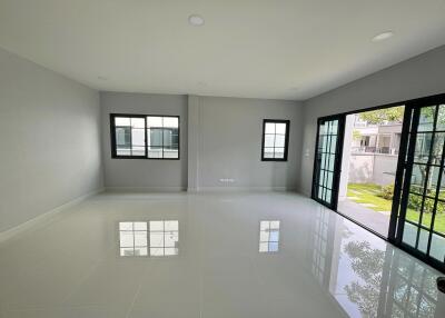 Spacious and bright living room with large windows and doors opening to the garden