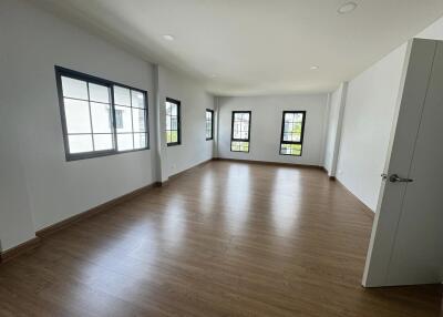 Spacious living room with windows and wood flooring