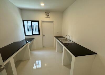 Modern kitchen with black countertops and white cabinetry