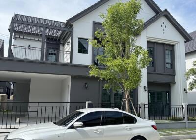 Modern two-story house with a white car parked in front