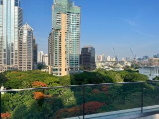 View from balcony showing cityscape and greenery