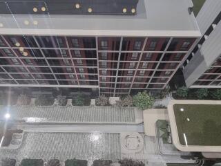 Aerial view of a modern apartment building with landscaped courtyard