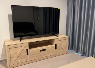 Living area with television and wooden TV stand