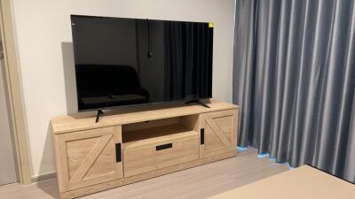 Living area with television and wooden TV stand