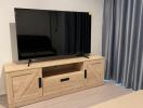 Living area with television and wooden TV stand