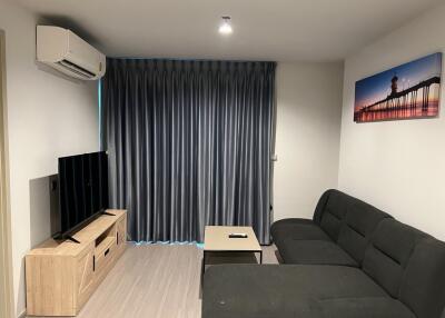 Modern living room with sofa and wall-mounted TV