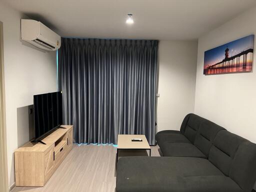 Modern living room with sofa and wall-mounted TV