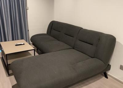 Modern living room with a grey sectional sofa and a coffee table