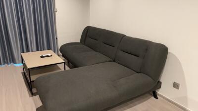 Modern living room with a grey sectional sofa and a coffee table