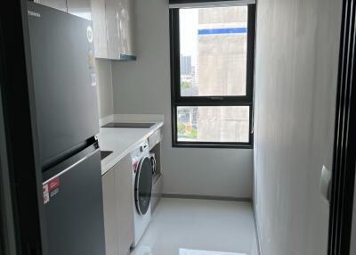 Laundry room with washer, dryer, cabinets, and natural light