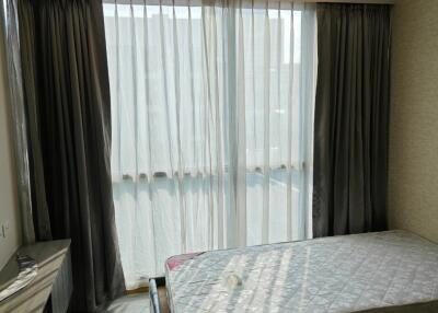 Bedroom with large windows and draped curtains