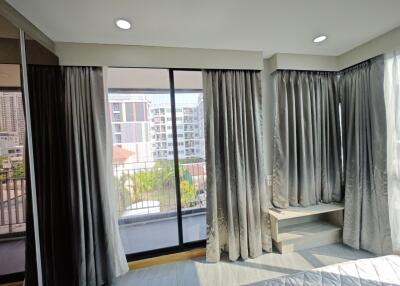 Bedroom with large windows and city view