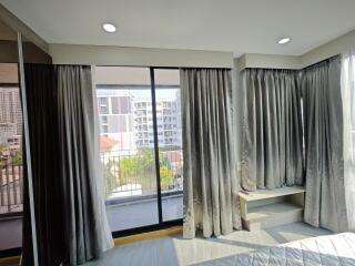 Bedroom with large windows and city view