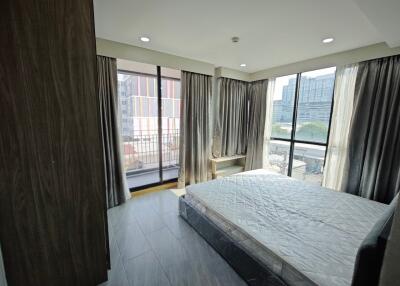 Bedroom with large windows and balcony view