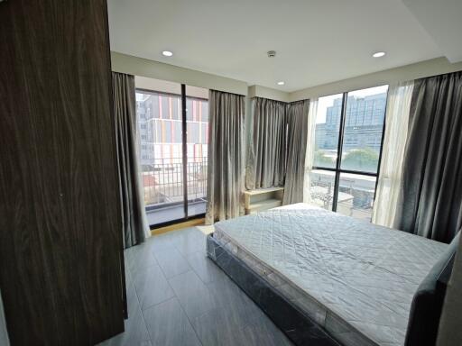 Bedroom with large windows and balcony view