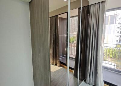 Modern bedroom with mirrored wardrobe and large windows