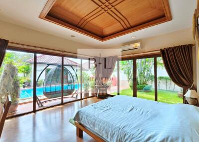 Spacious bedroom with pool view and ample natural light